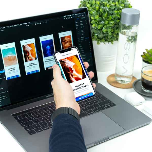 Hand holding phone with design concept displayed